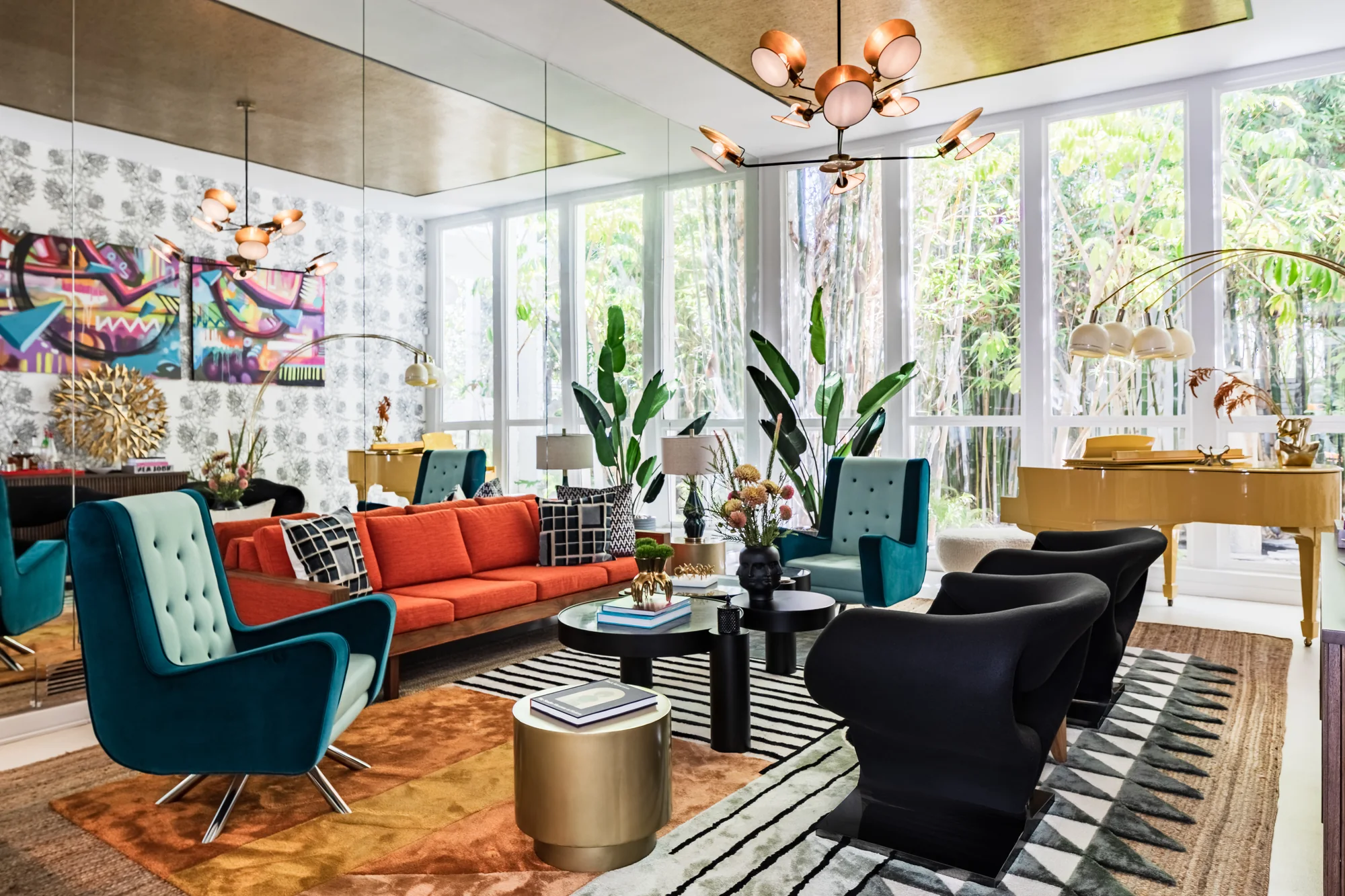 Living room with a grand piano, orange sofa and floral wallcovering