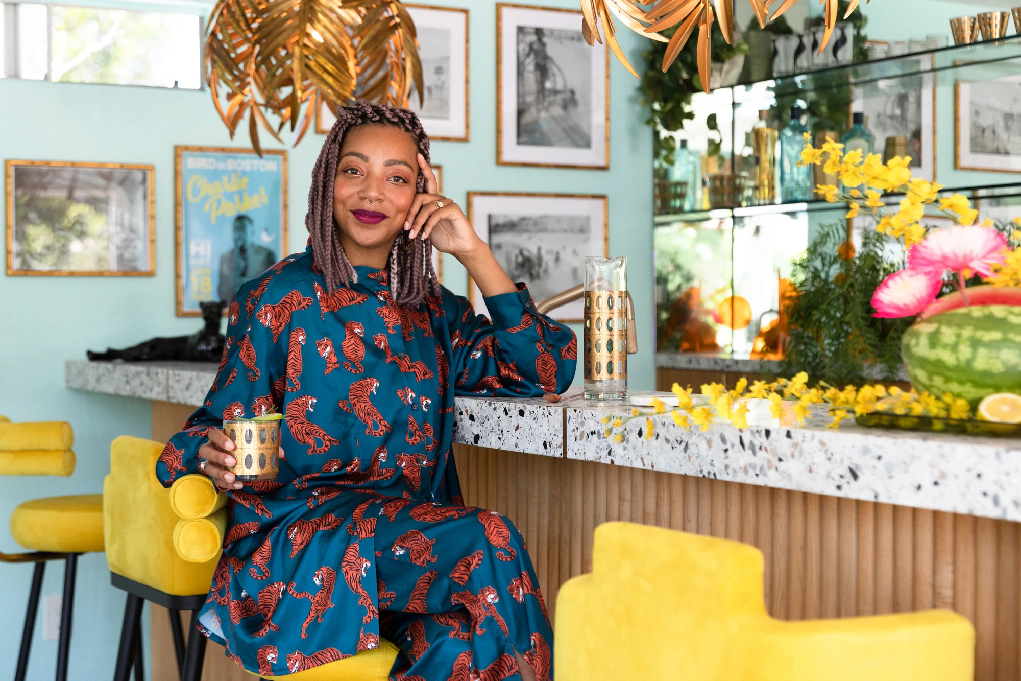 Carmen at the pool-house bar in a printed jumpsuit