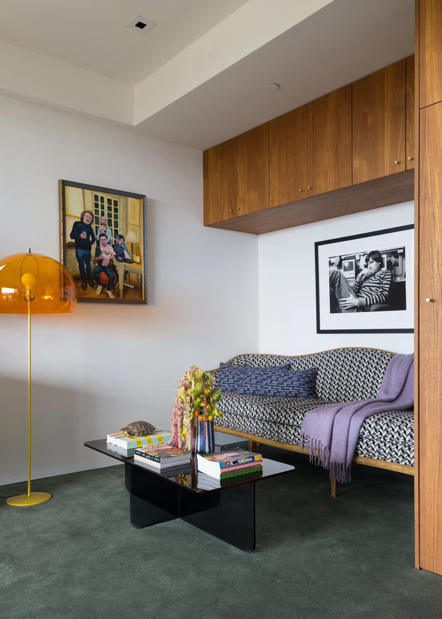 Sitting room with a patterned sofa and an orange dome lamp