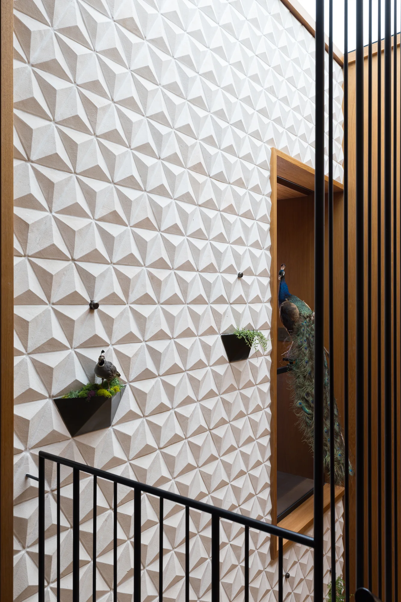 Detail of the faceted tile wall with its planter pockets